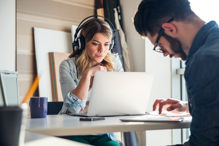 woman listening to podcast whilst working